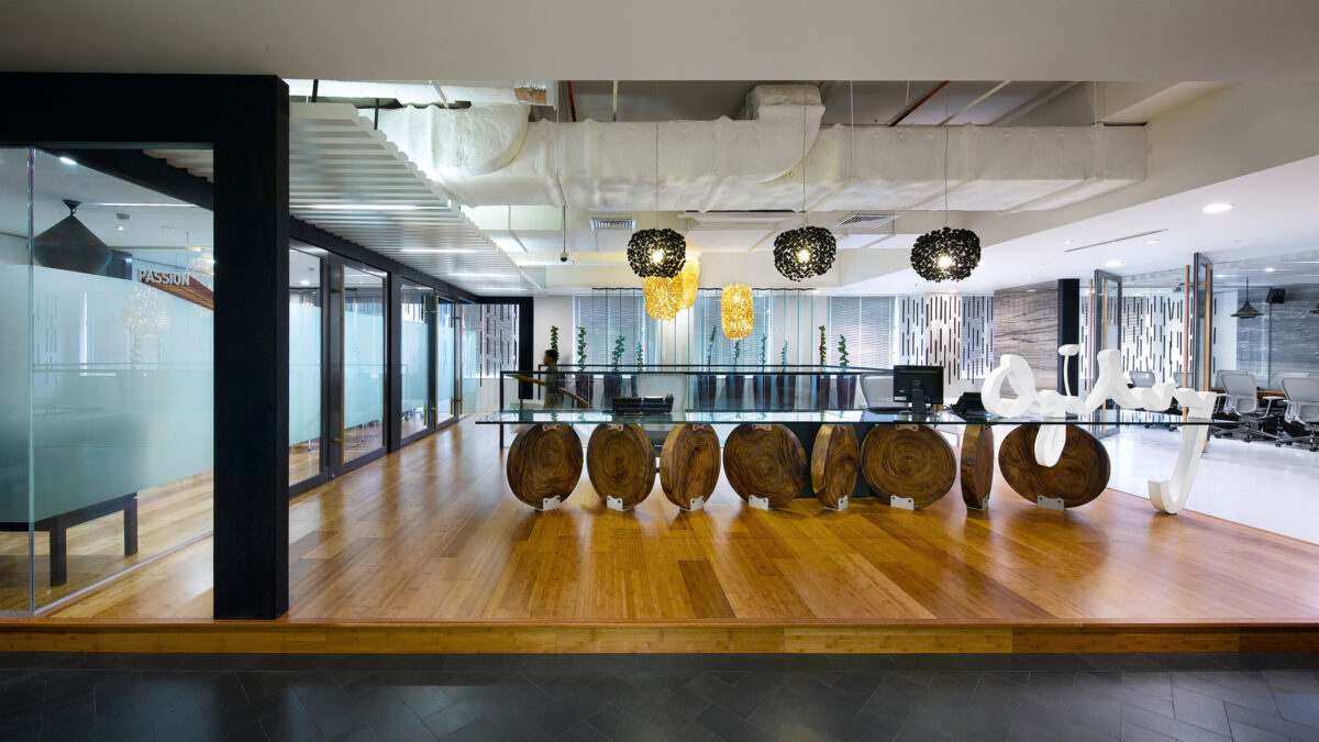 partial wood floor, meeting room, view of logo and someone walking up staircase