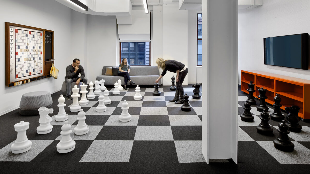 people playing chess and a game in breakout area
