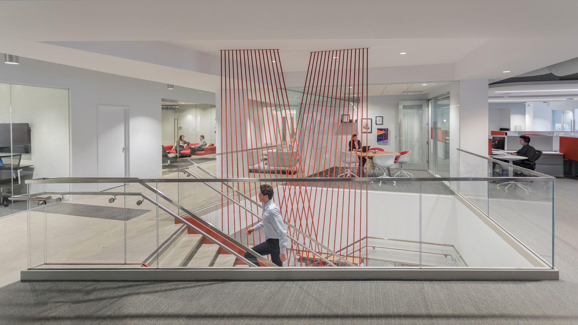 staircase with red string artwork connecting floors