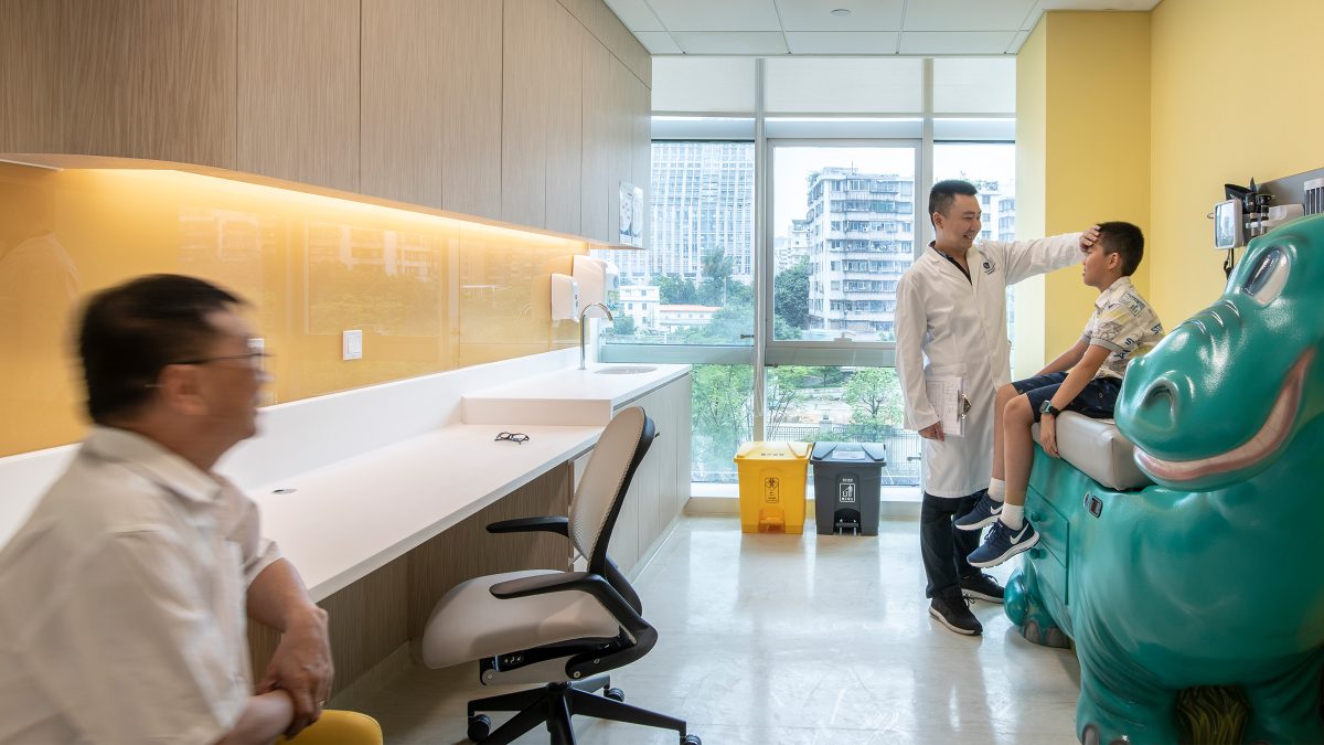 child being examined in hospital room