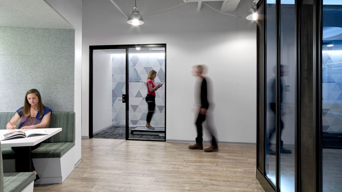 woman working in booth and people walking