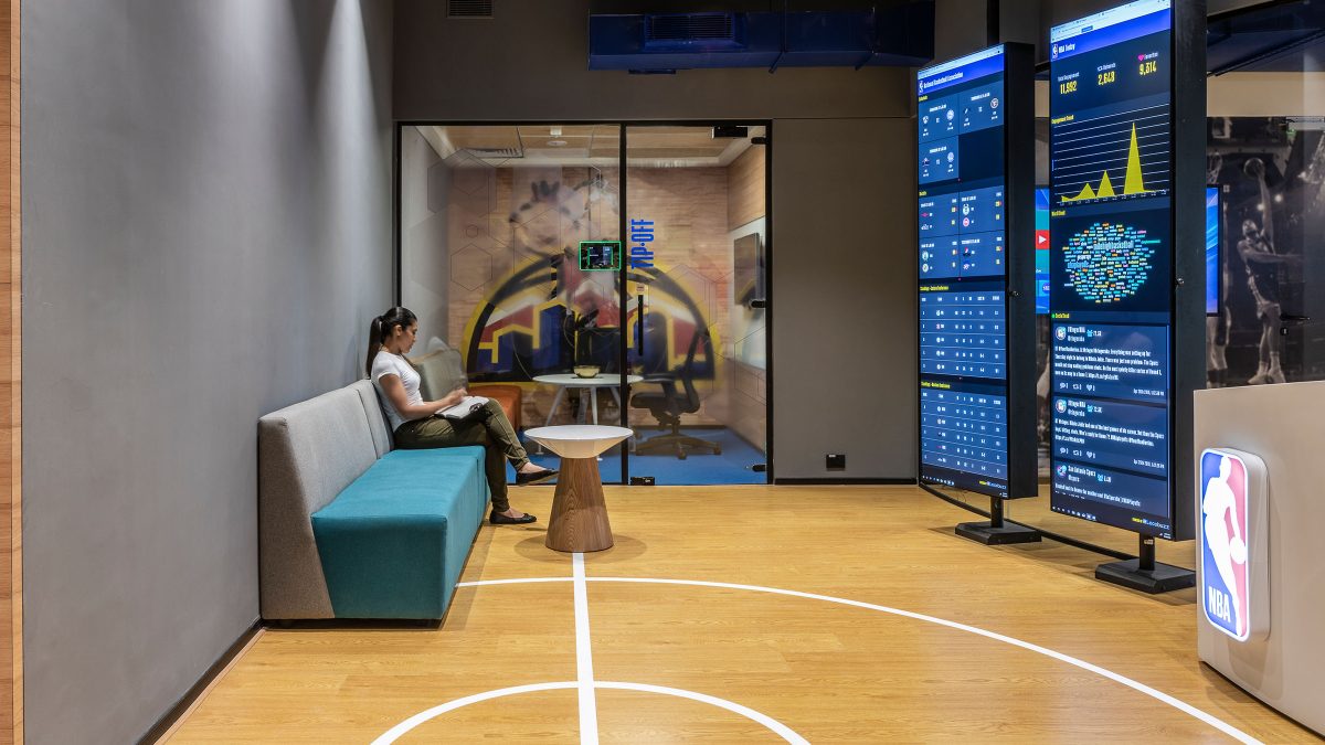 Comfortable work bench featuring live screens of basketball games.