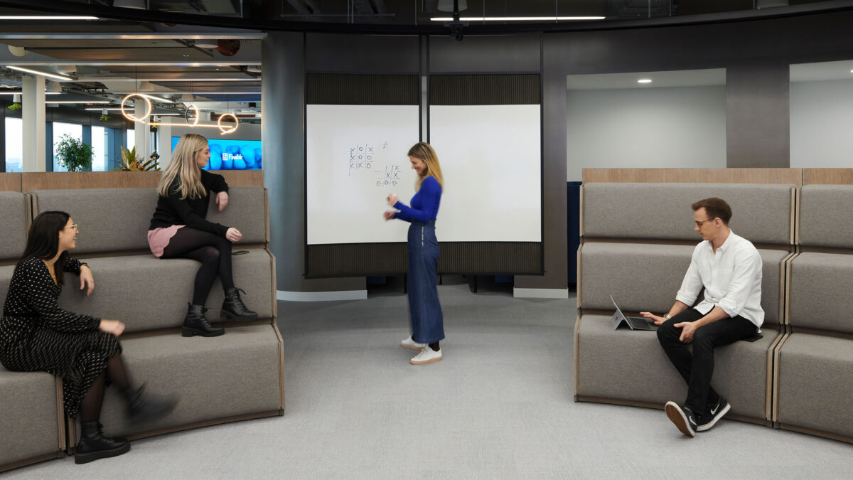 Woman giving presentation to colleagues