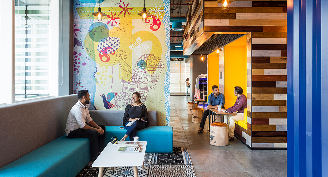 people collaborating in casual seating and people in booth