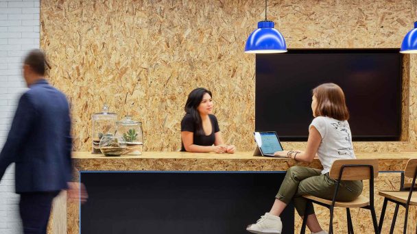 OSB wall in workplace with women talking