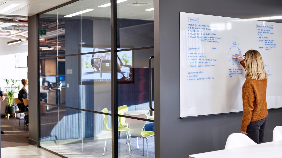 woman writing on whiteboard