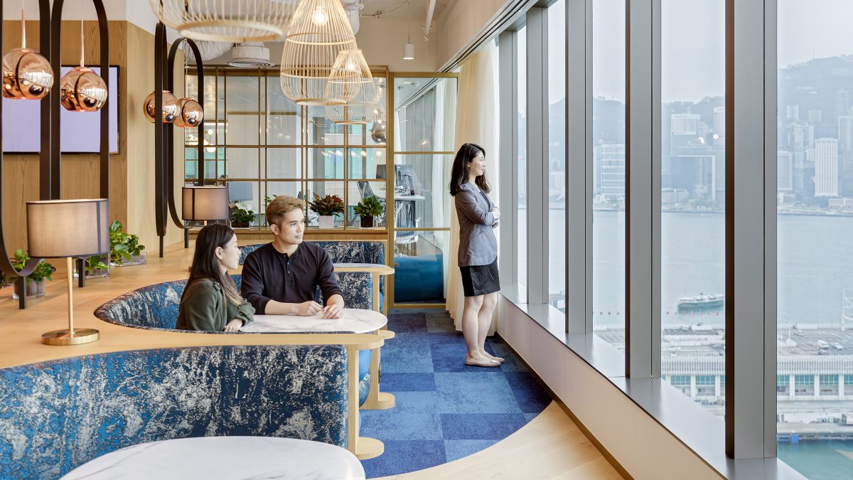 people collaborating and woman looking out of window