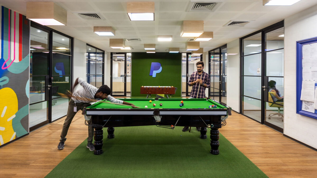people playing pool, logo in background