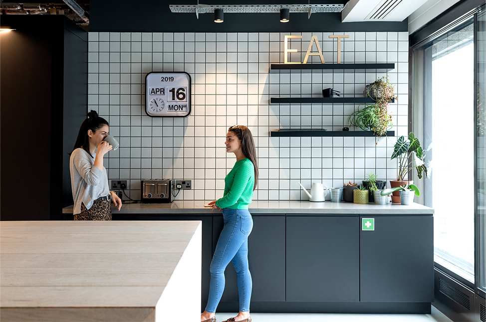 colleagues talking in kitchen