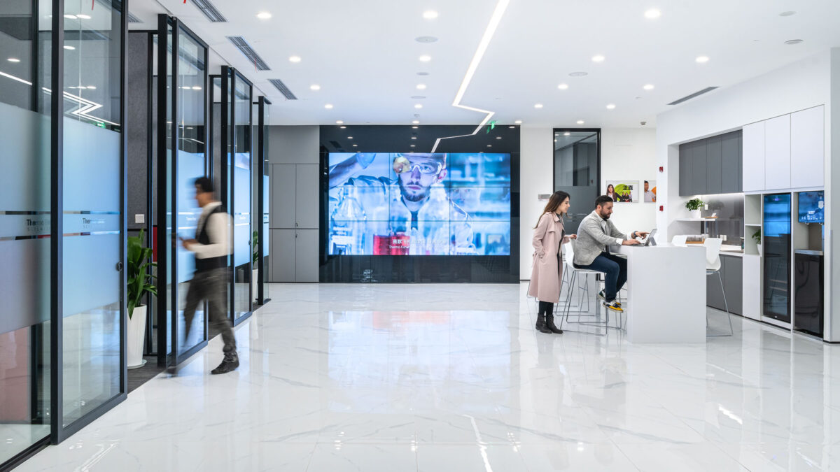 people in kitchen, man walking into meeting room and av wall large version