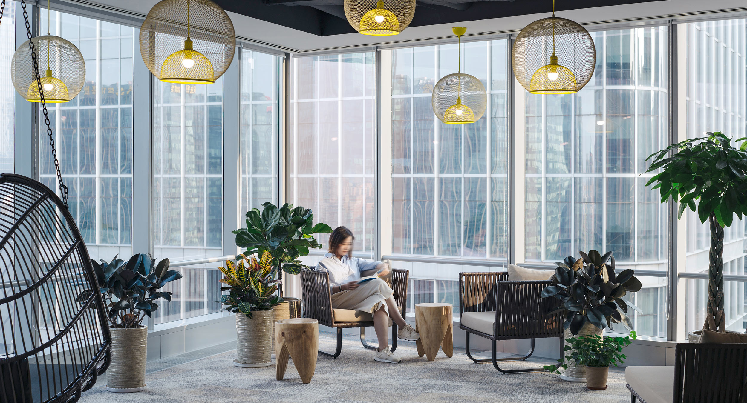 woman in seating beside office window