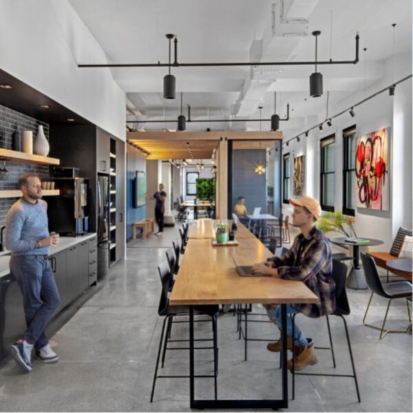 Corporate kitchen design by M Moser featuring spacious amenity space for employee breaks.
