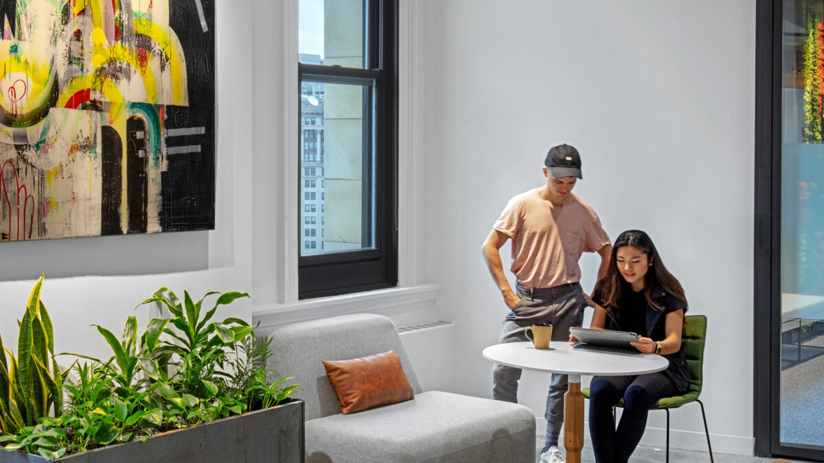 two people collaborating over small table