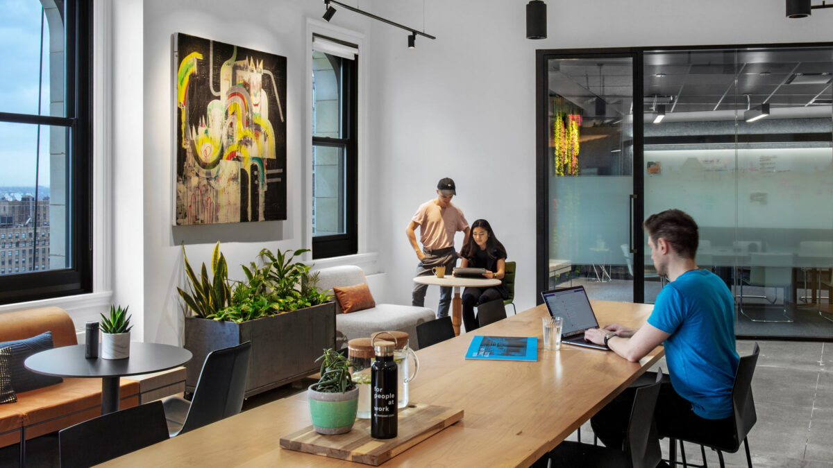 people collaborating in office kitchen