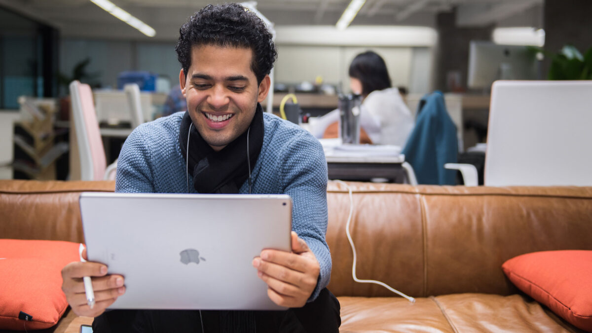 man working on laptop on couch