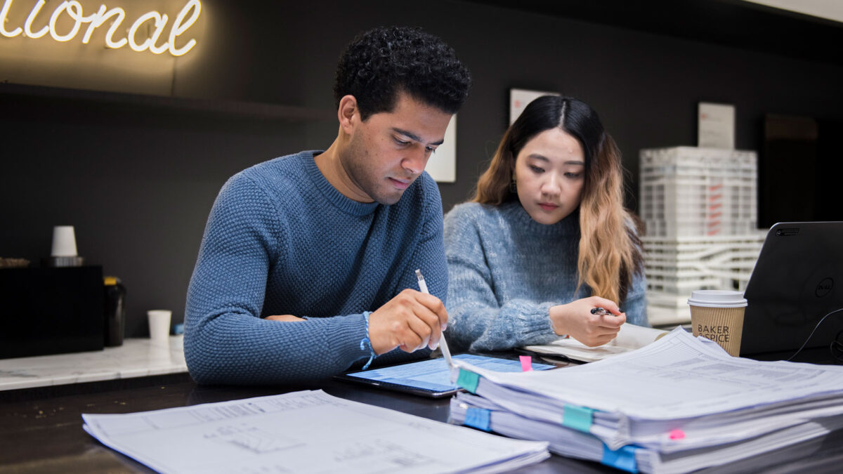 man and woman working together on tablet