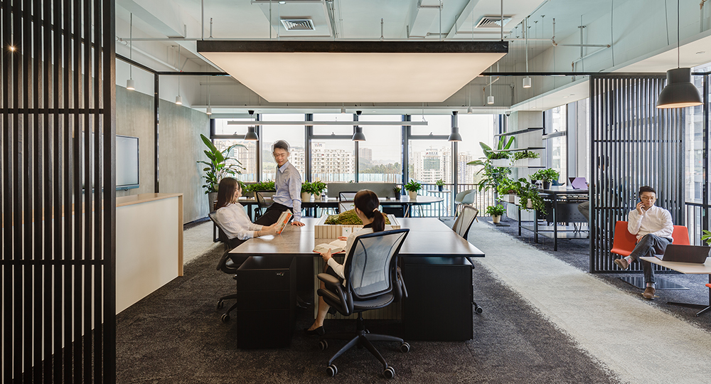 people at desks and man sitting