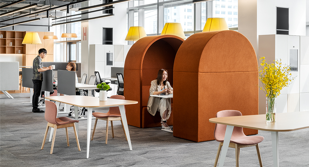 woman in booth, man and woman collaborating 