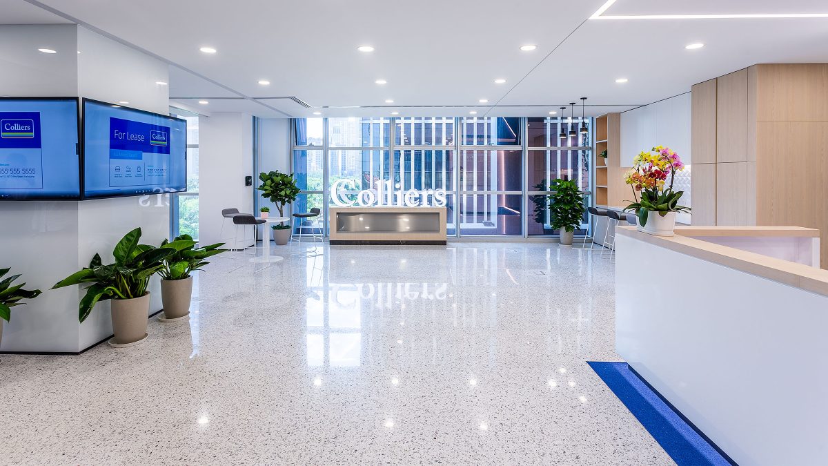 Reception desk, with plants and view of logo