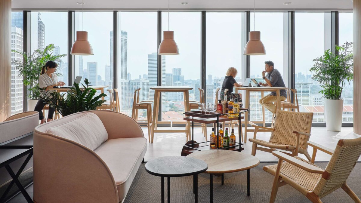 people working at desks with visible drinks