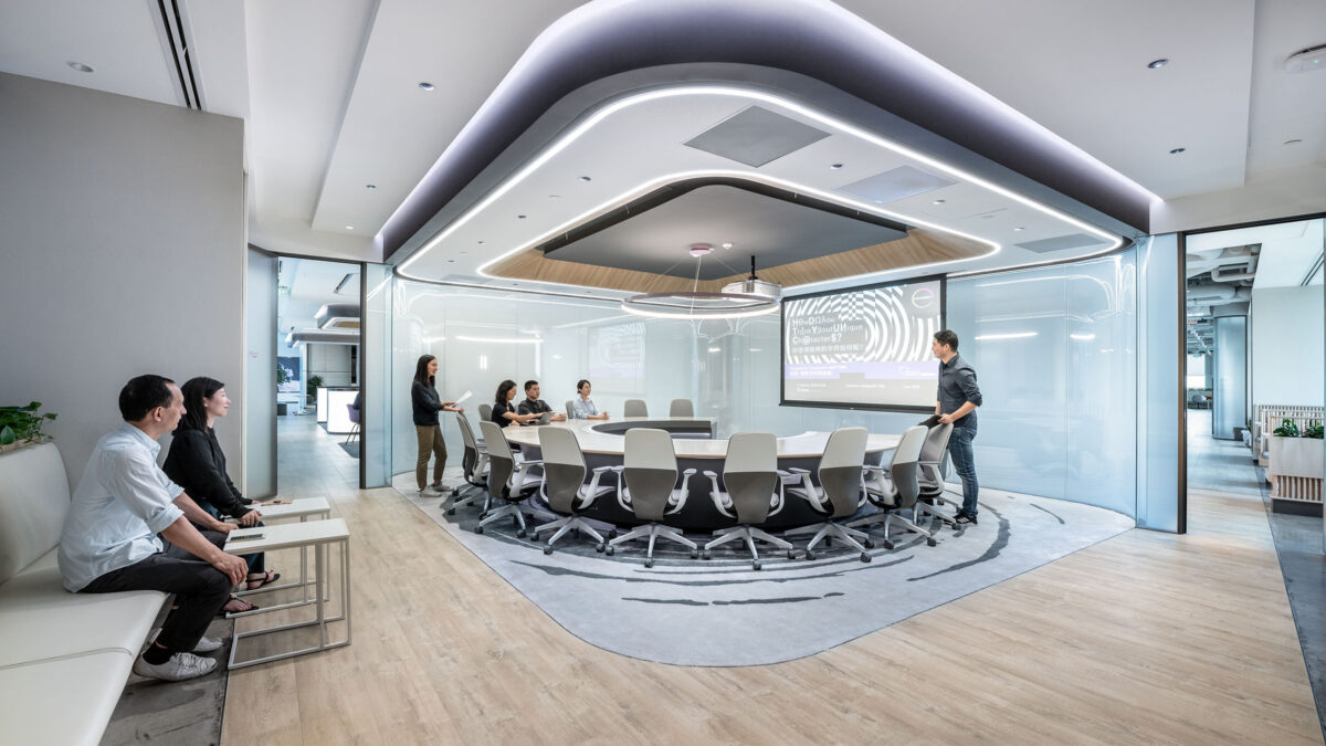 man giving presentation in meeting room to colleagues