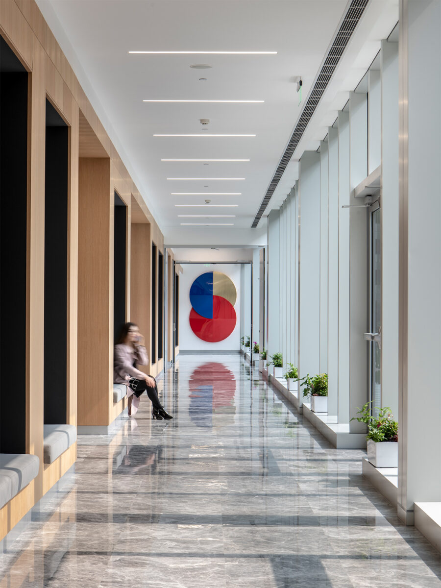 Man sitting in long corridor