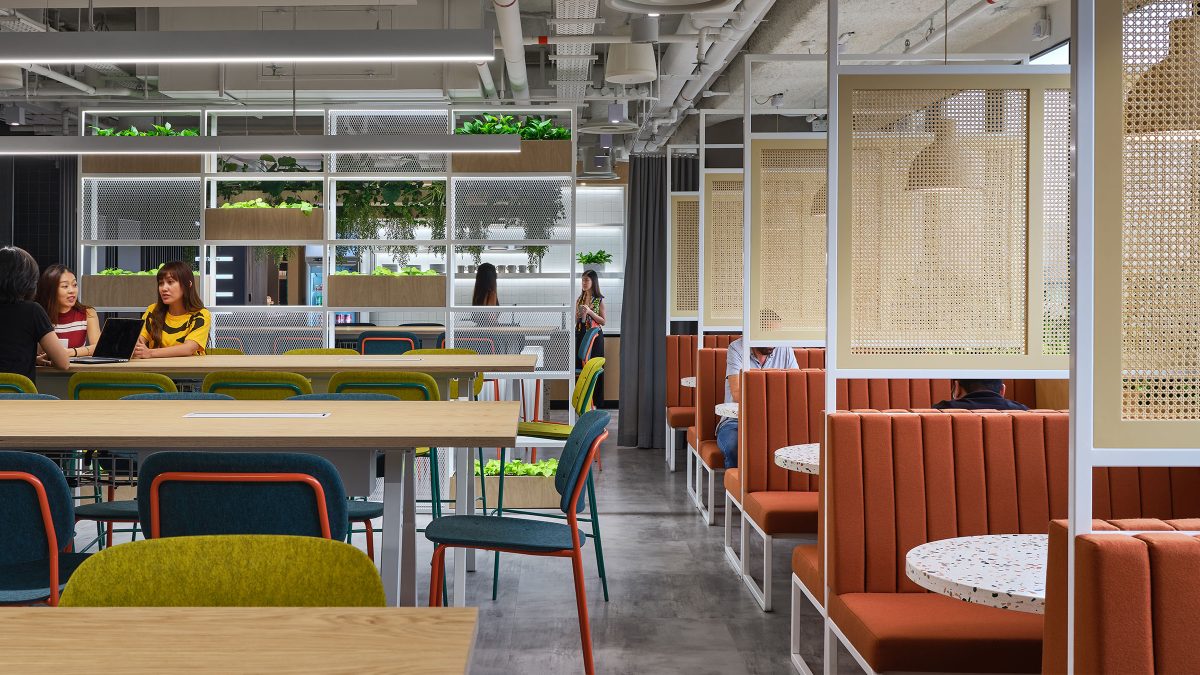 people collaborating at table and view of booths