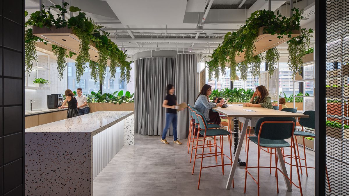 People in kitchen area and women at table