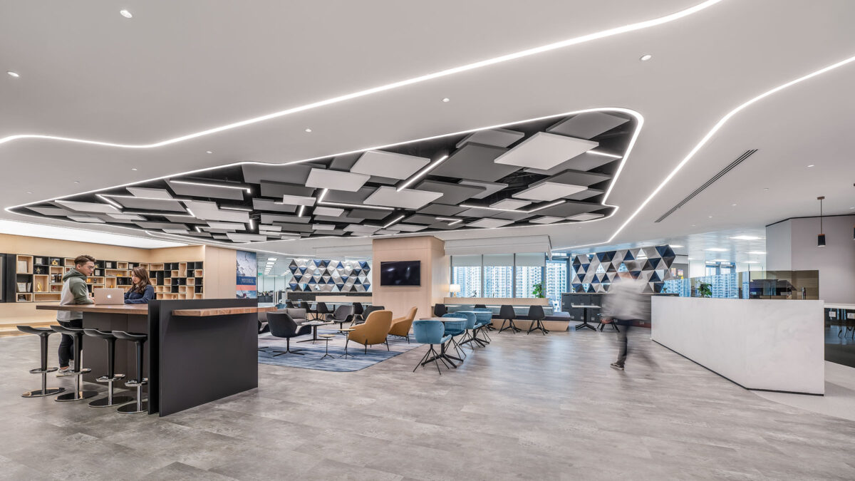 people collaborating at counter and man walking towards desk