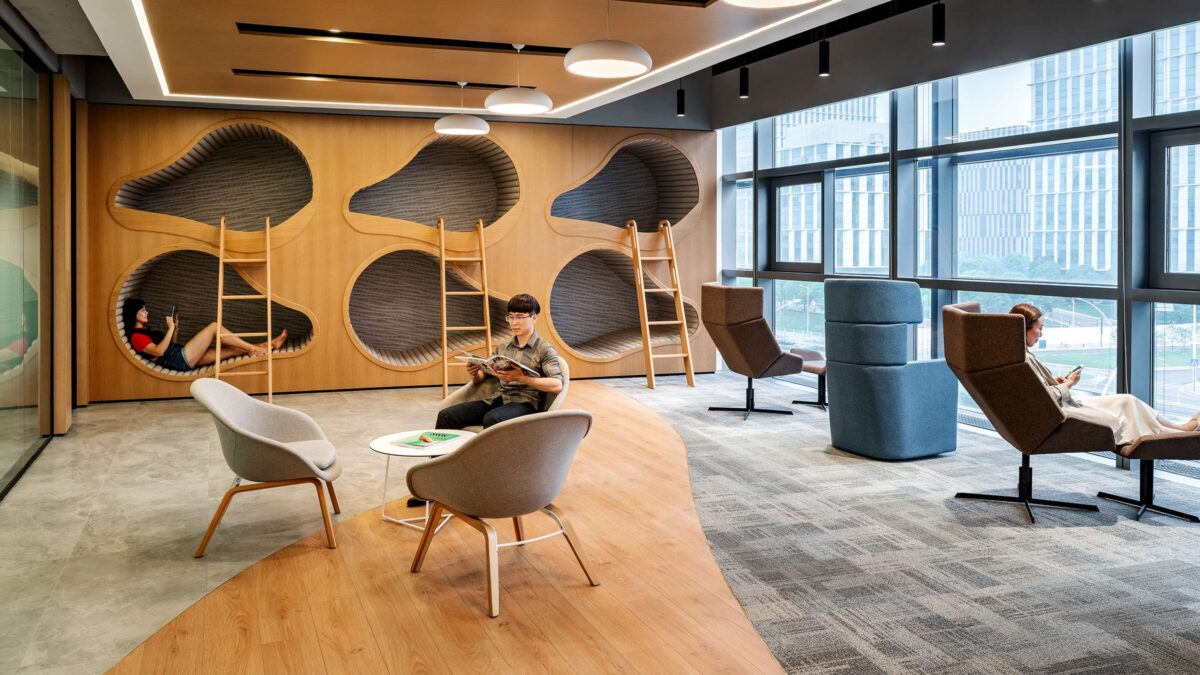 people working in casual seating area in a booth and on seats