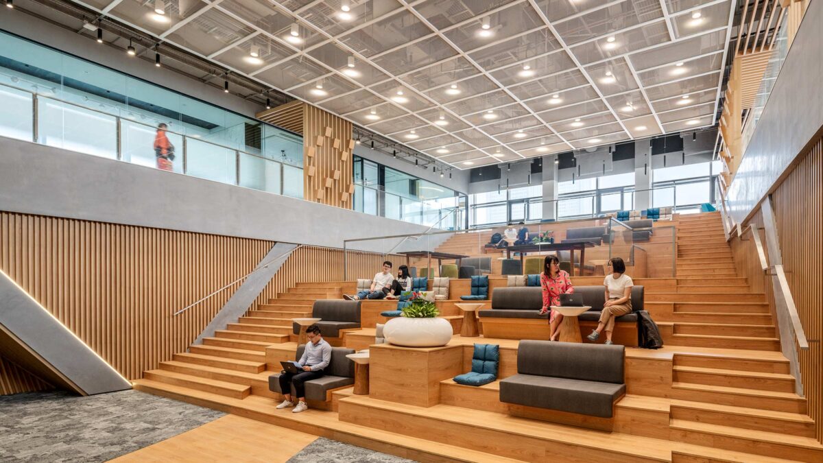 people sitting on tiered staircase collaborating