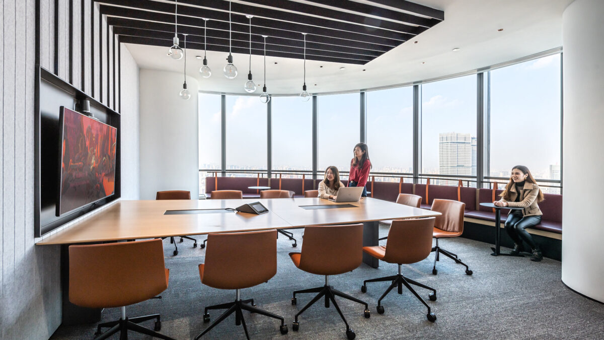 people in meeting rooms working