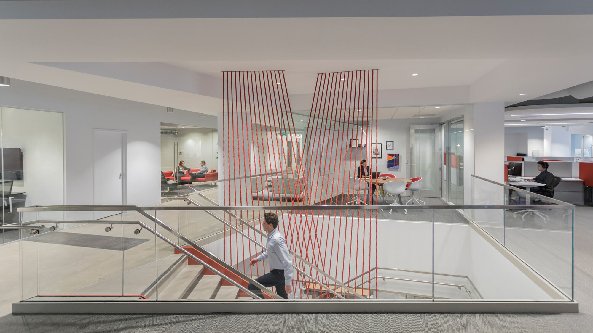 staircase with red string artwork connecting floors