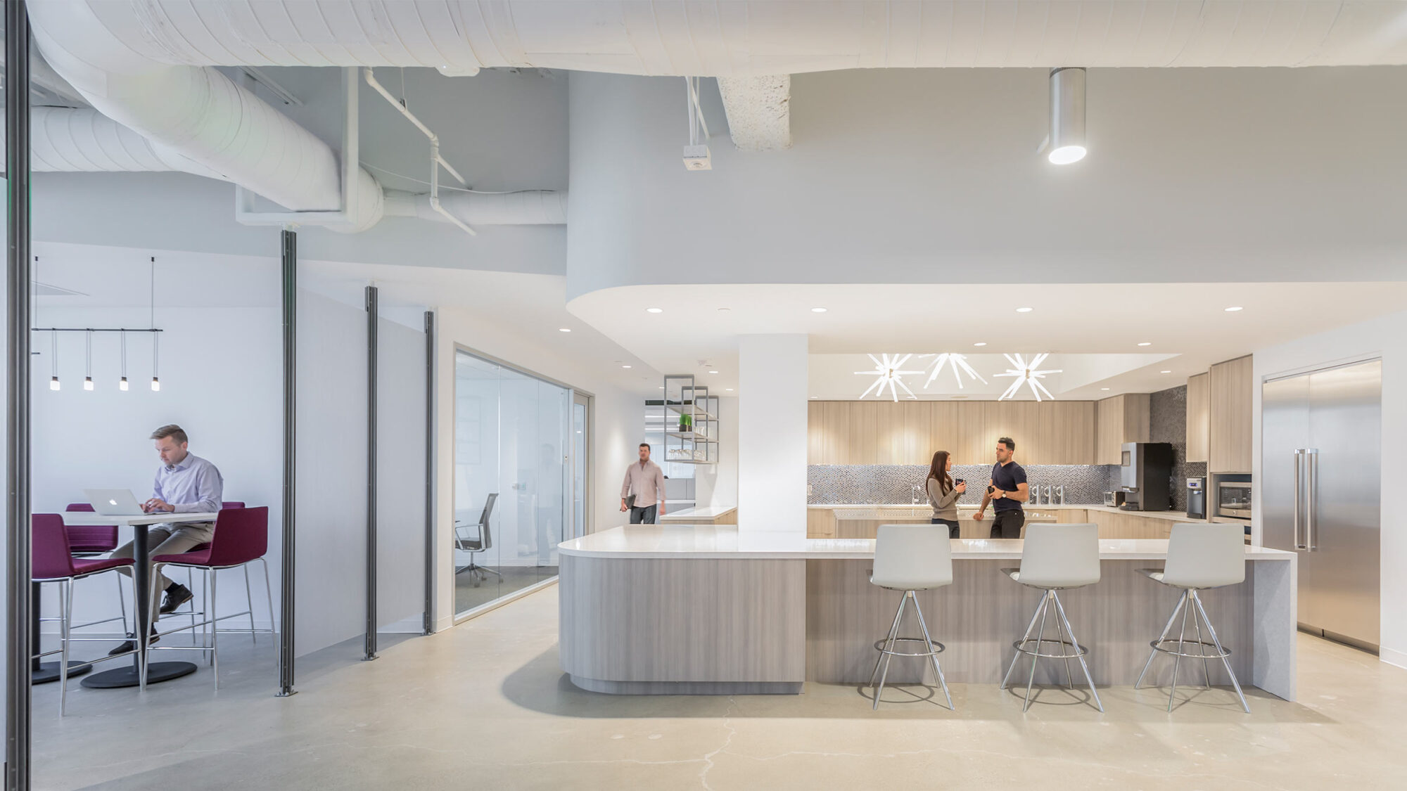 light coloured kitchen space with people talking