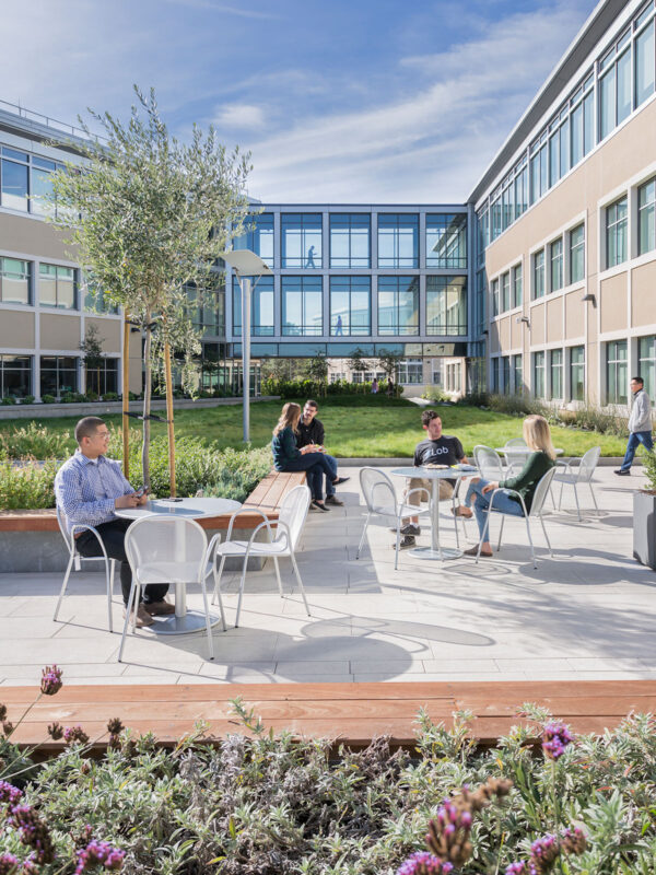 people sitting outside in workplace courtyard