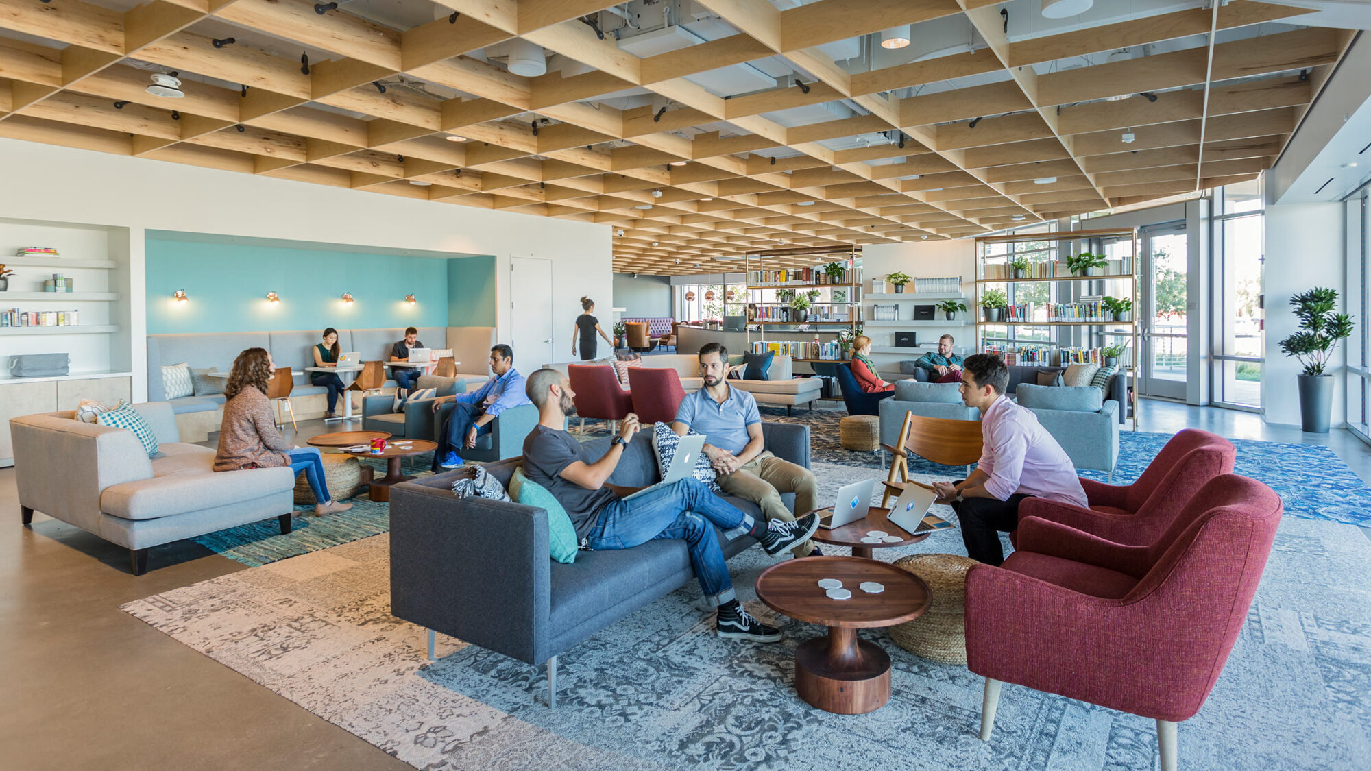 large groups of people chatting in office social area