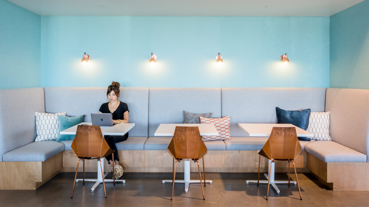 woman working in cafe bench style seating