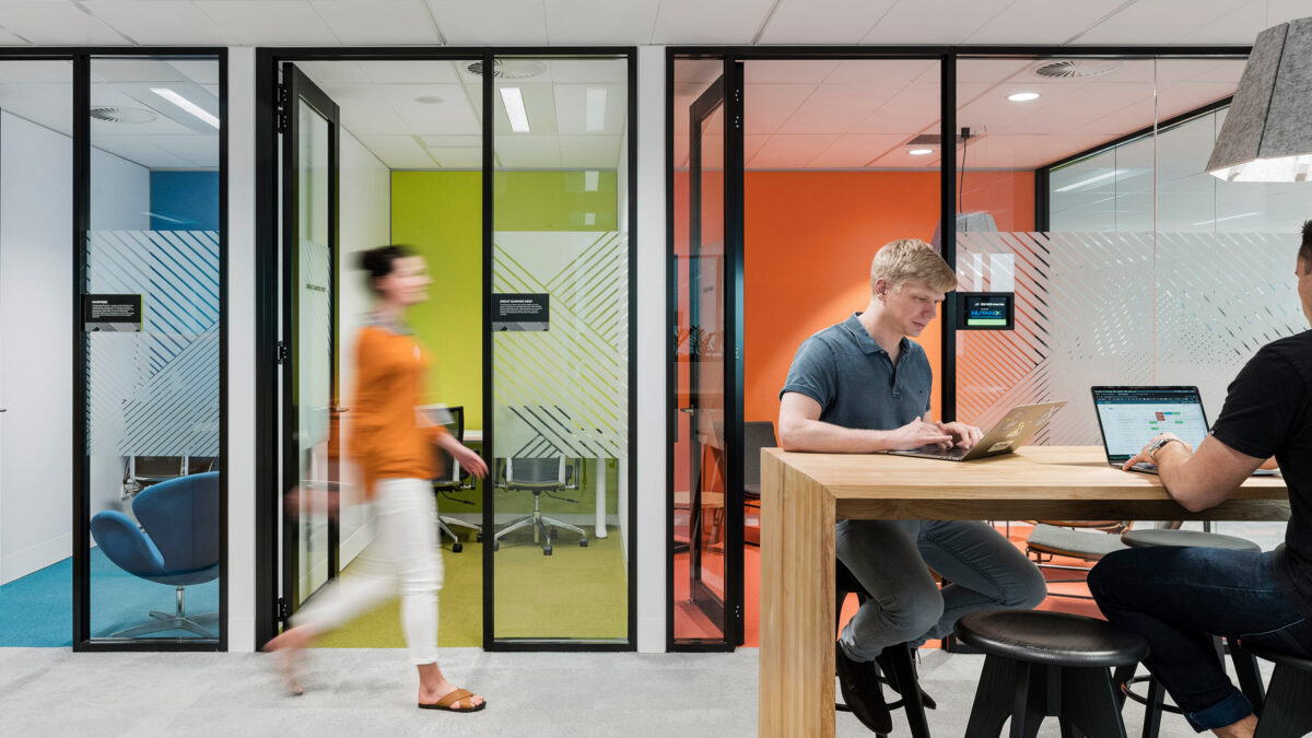 people sitting at table in front of colourful rooms