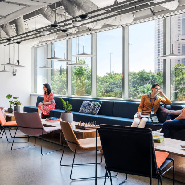 people sitting in lounge space beside window