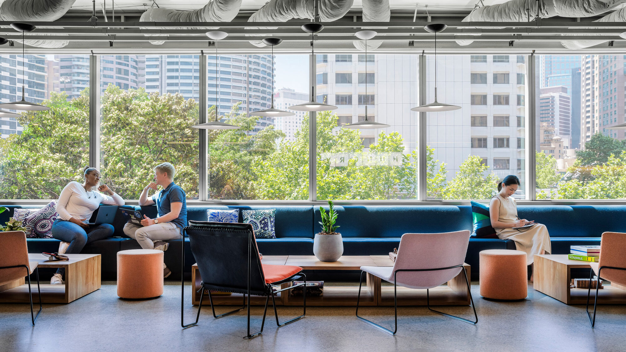 people sitting in lounge space beside window