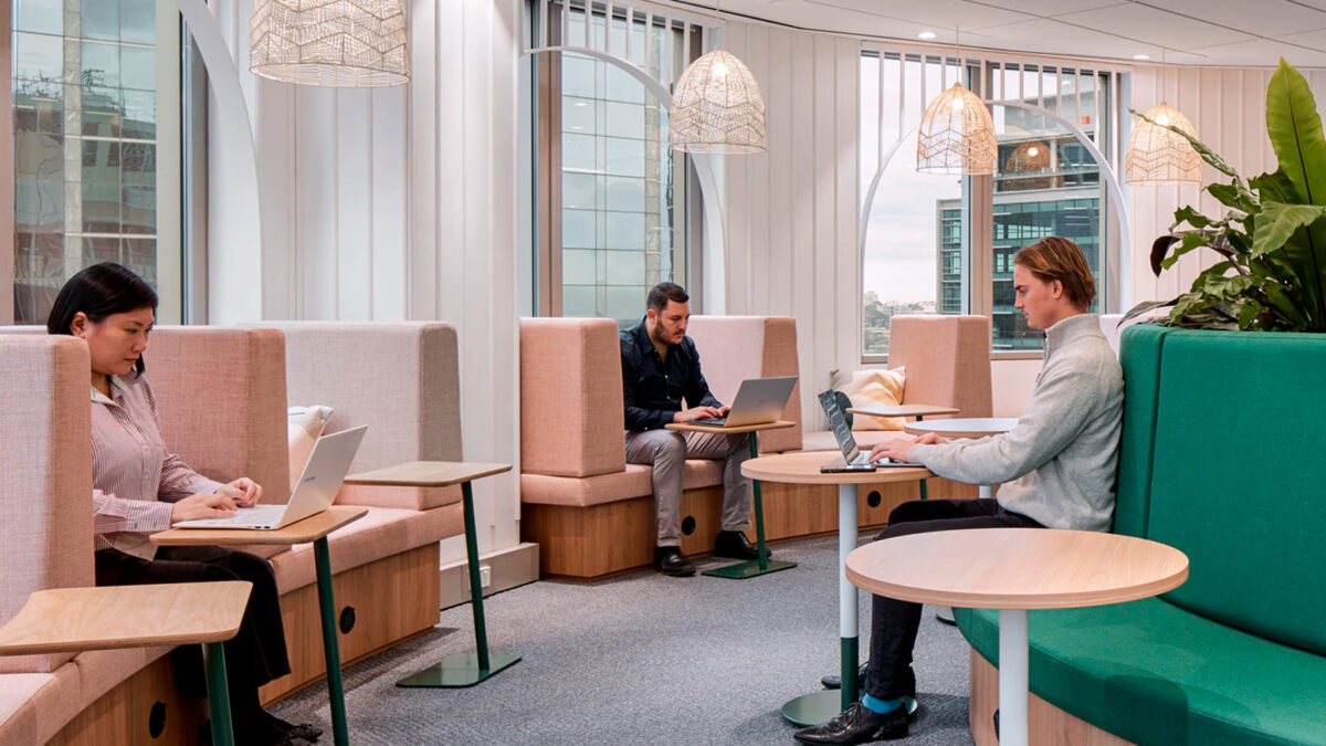 people sitting in booth workspaces