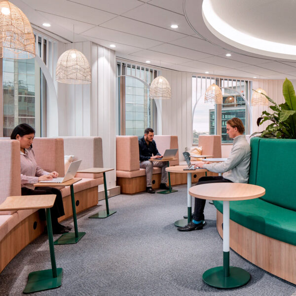 people sitting in booth workspaces