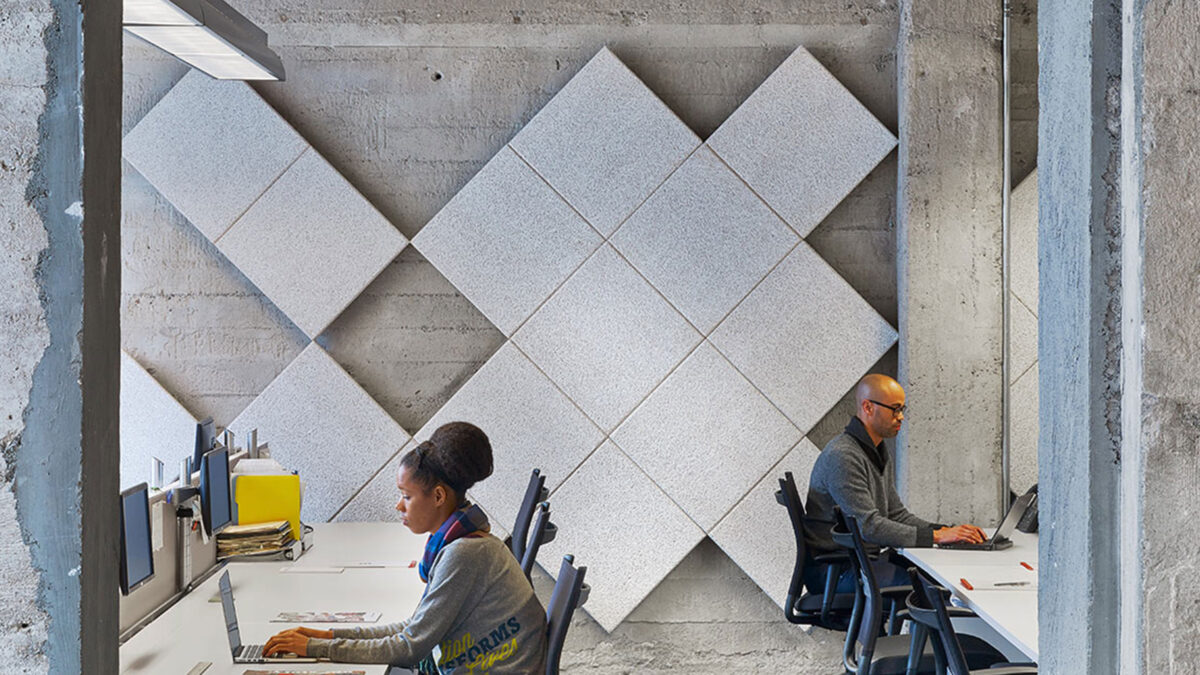 raw concrete portal leading to desks