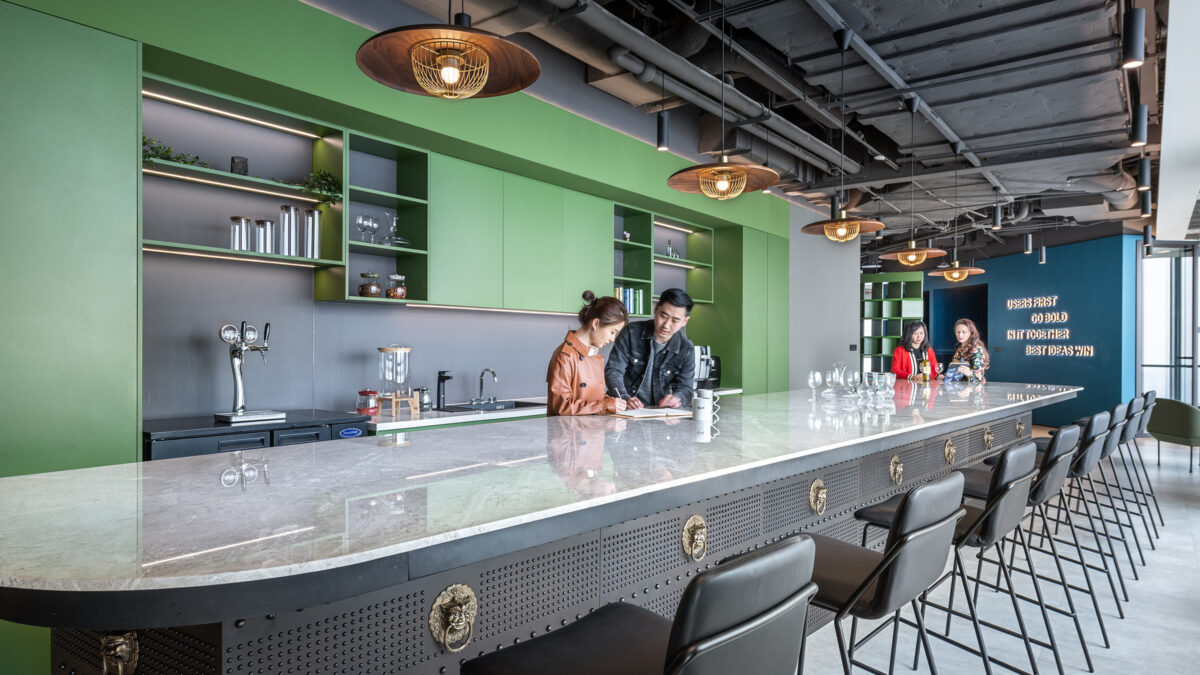 green kitchen space with people talking