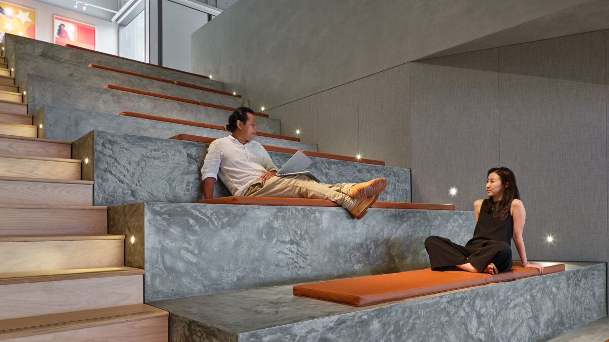 man and woman sitting on stage seating