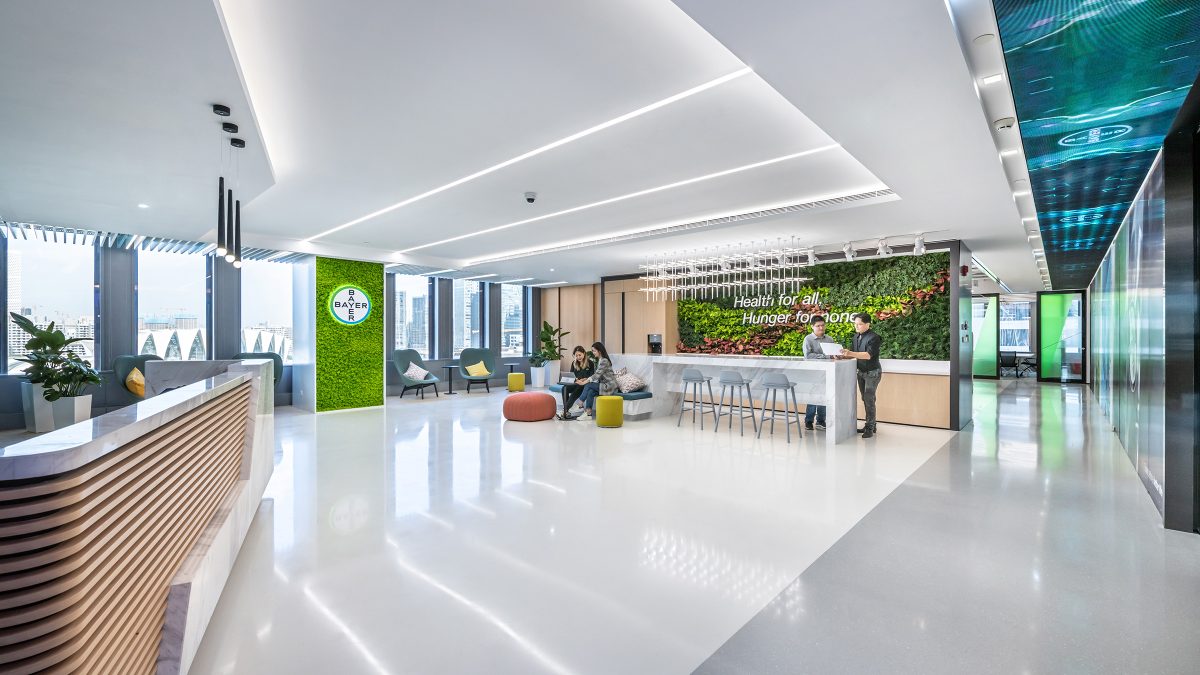 reception and people collaborating in lounge area space of workplace