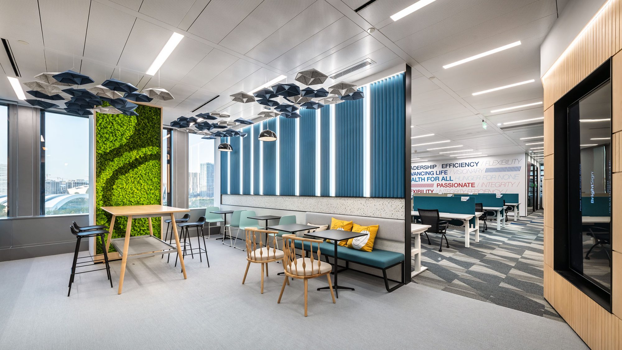 breakout area and green wall with view of open plan area