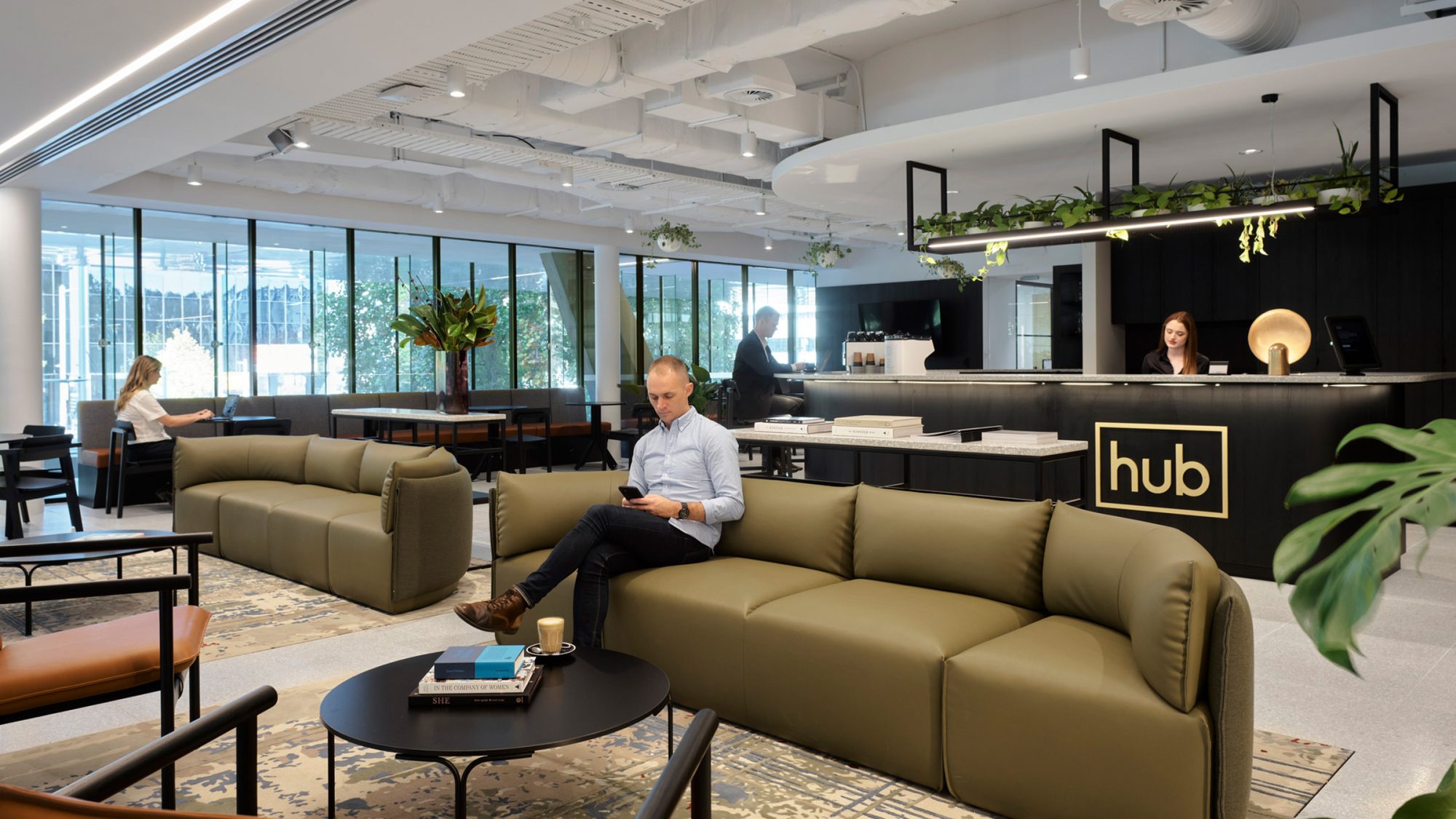 reception and man sitting in lounge area