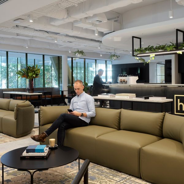 reception and man sitting in lounge area