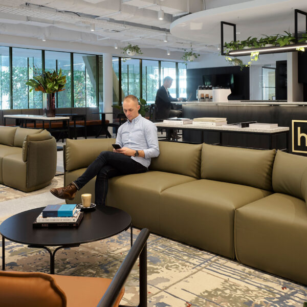 reception and man sitting in lounge area